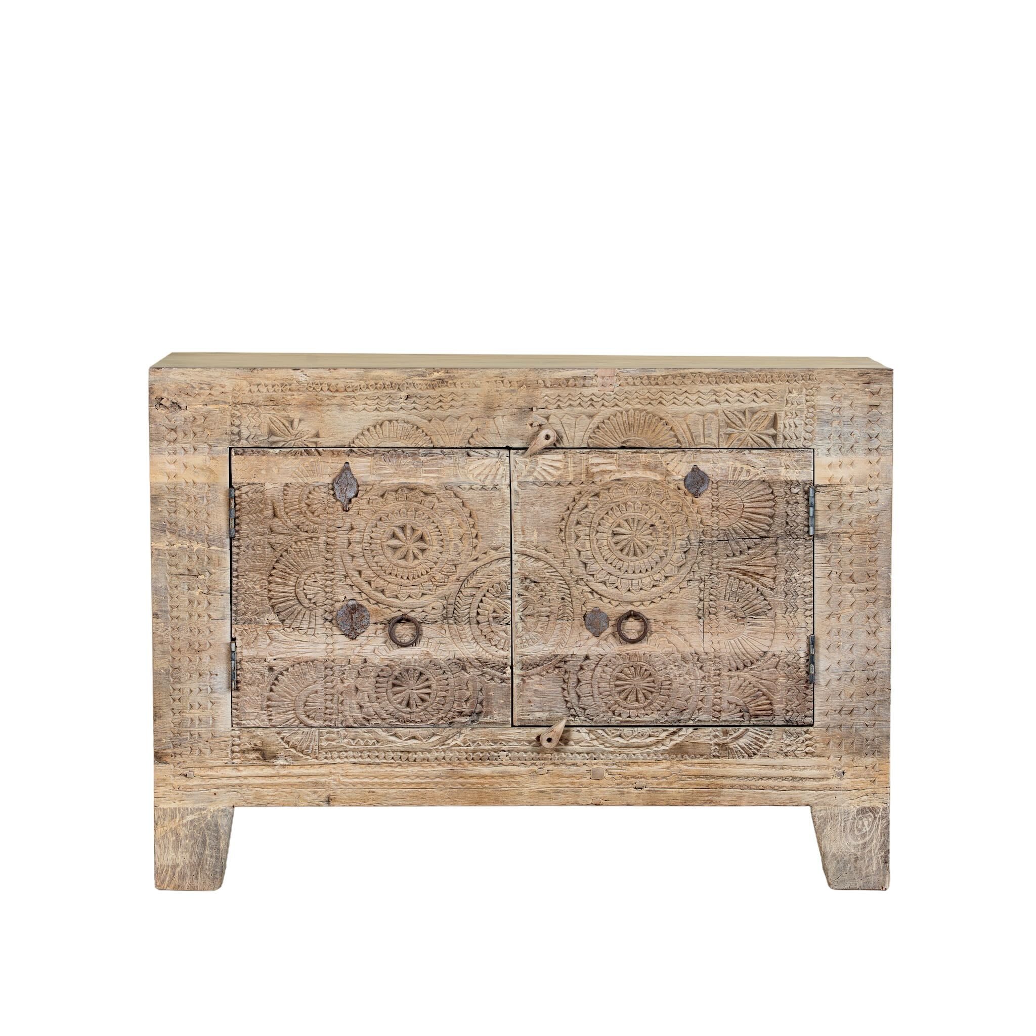 White background image of a sideboard Taksh made from reclaimed teak wood, featuring carved antique Indian door fronts with circular mandala motifs. A unique piece of old door furniture combining Mediterranean style with traditional Indian craftsmanship.