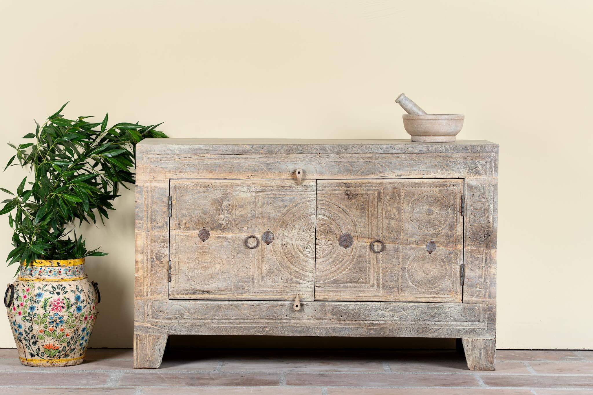 Handcrafted sideboard Tanay made from reclaimed teak wood, featuring antique Indian door fronts with original carvings. A Mediterranean-inspired piece of unique Indian furniture with sustainable character and functional storage.