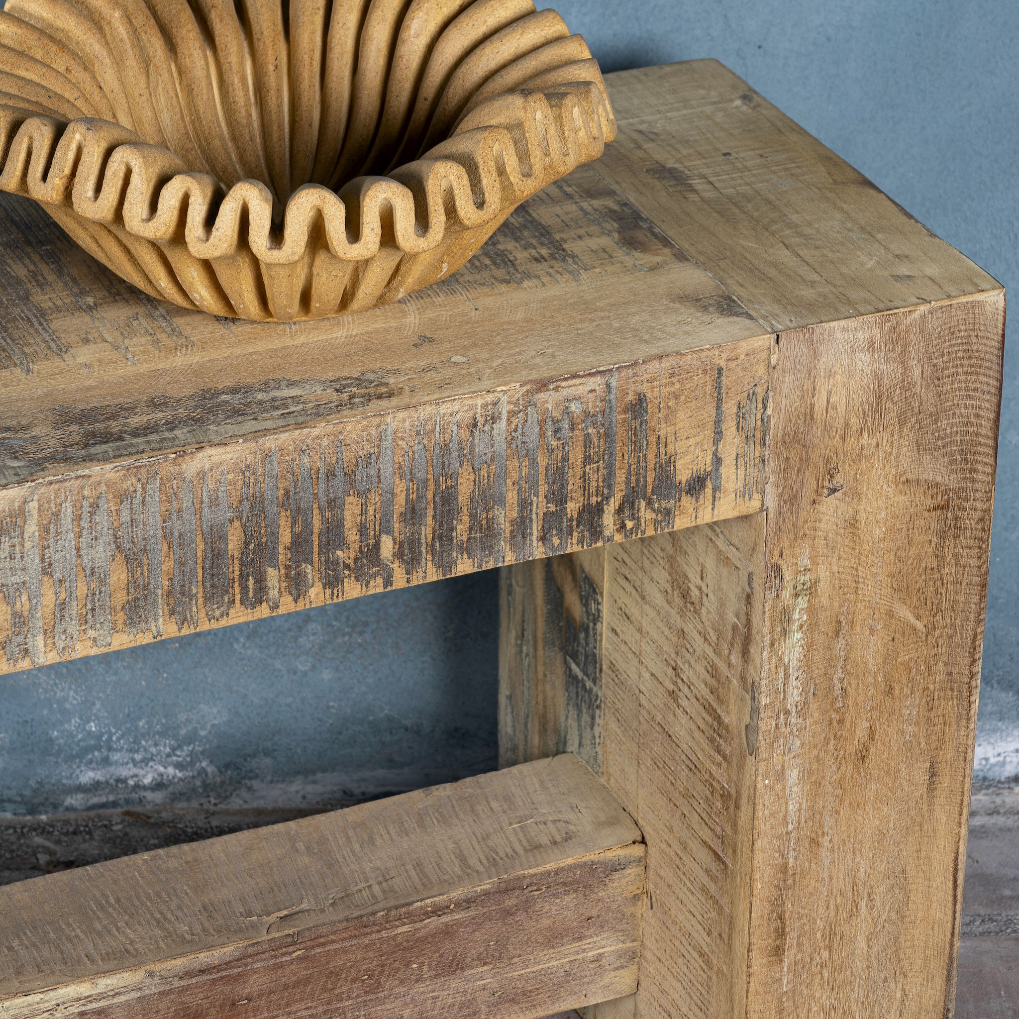 Close up image of a reclaimed teak wood bench with rustic finish and minimalist frame; sustainable furniture, 160 × 30 × 50 cm.
