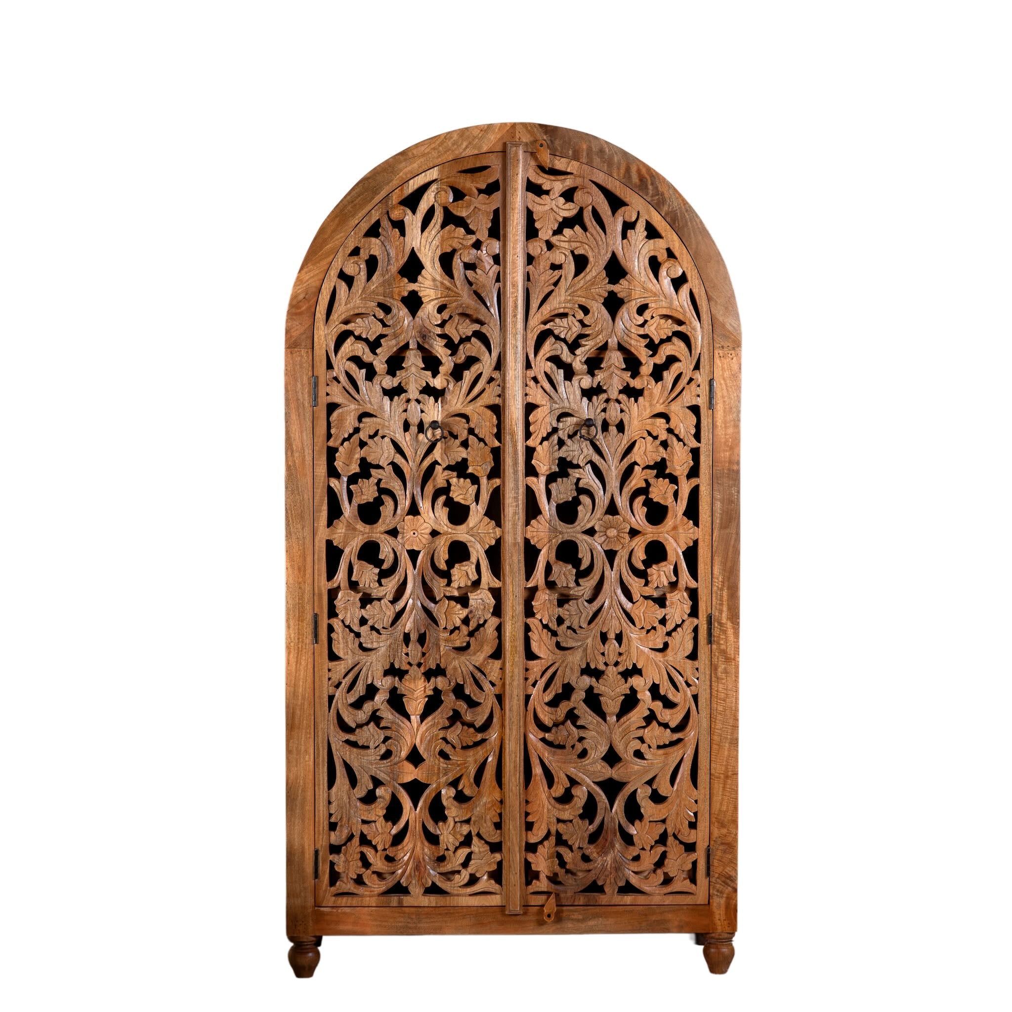 White background image of a hand carved wooden wardrobe with arc-shaped cabinet design in solid mango wood – Aranya model by Om Home & Garden