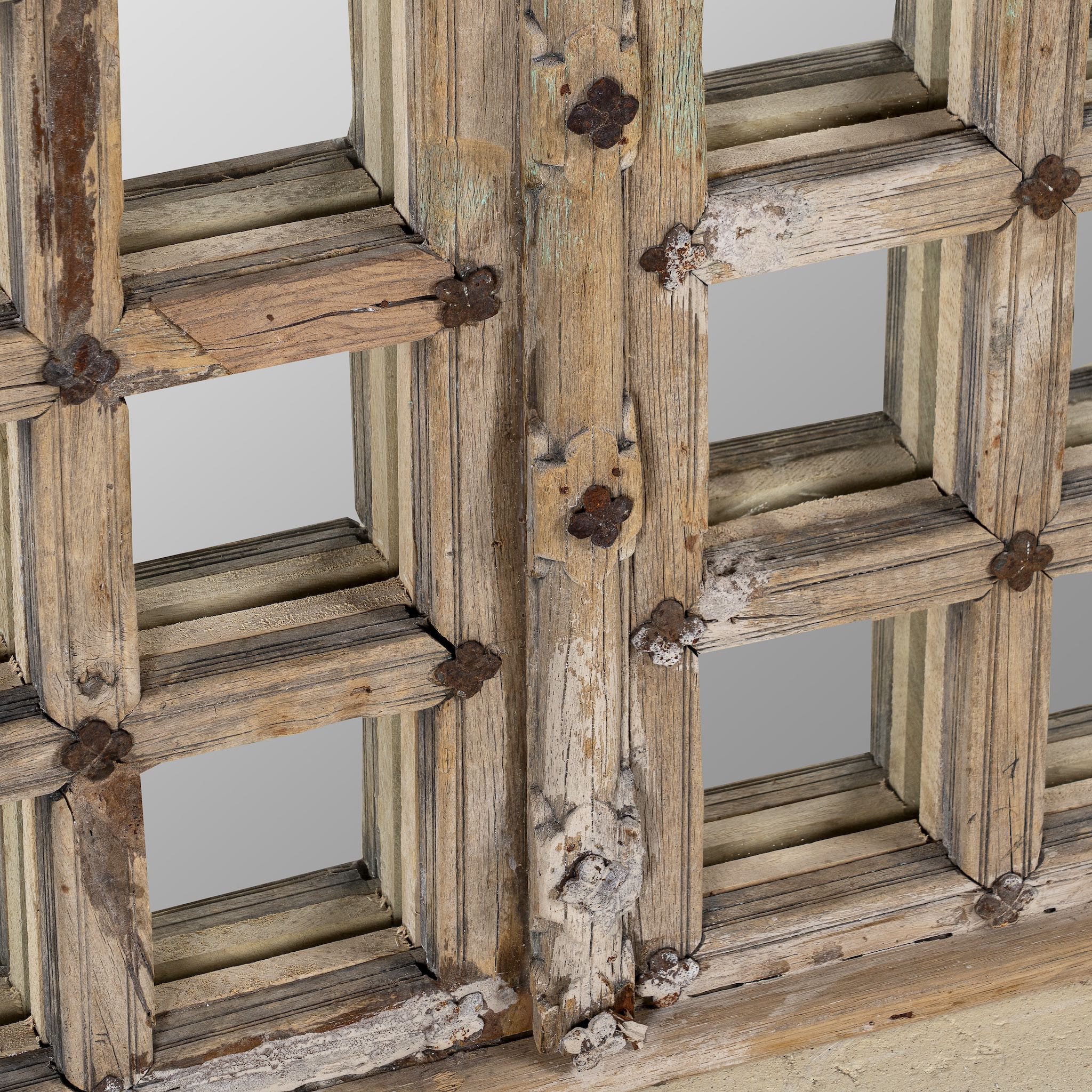 Close up of a wooden door mirror with antique teak frame and carvings, part of our Indian home decor collection.