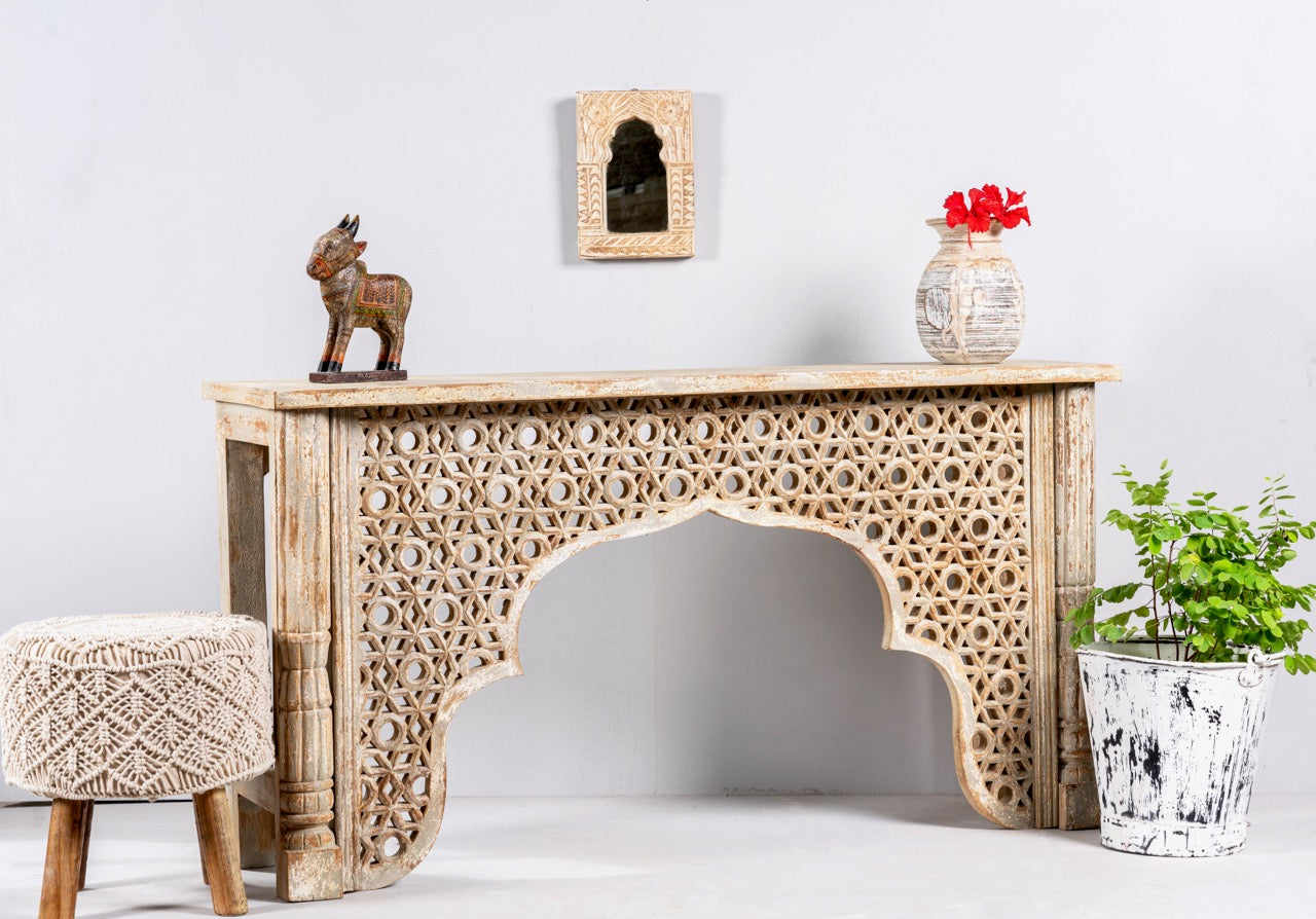 Side angle image of a hand carved mango wood console table in oriental style; unique hand carved furniture, 150 × 80 × 40 cm.