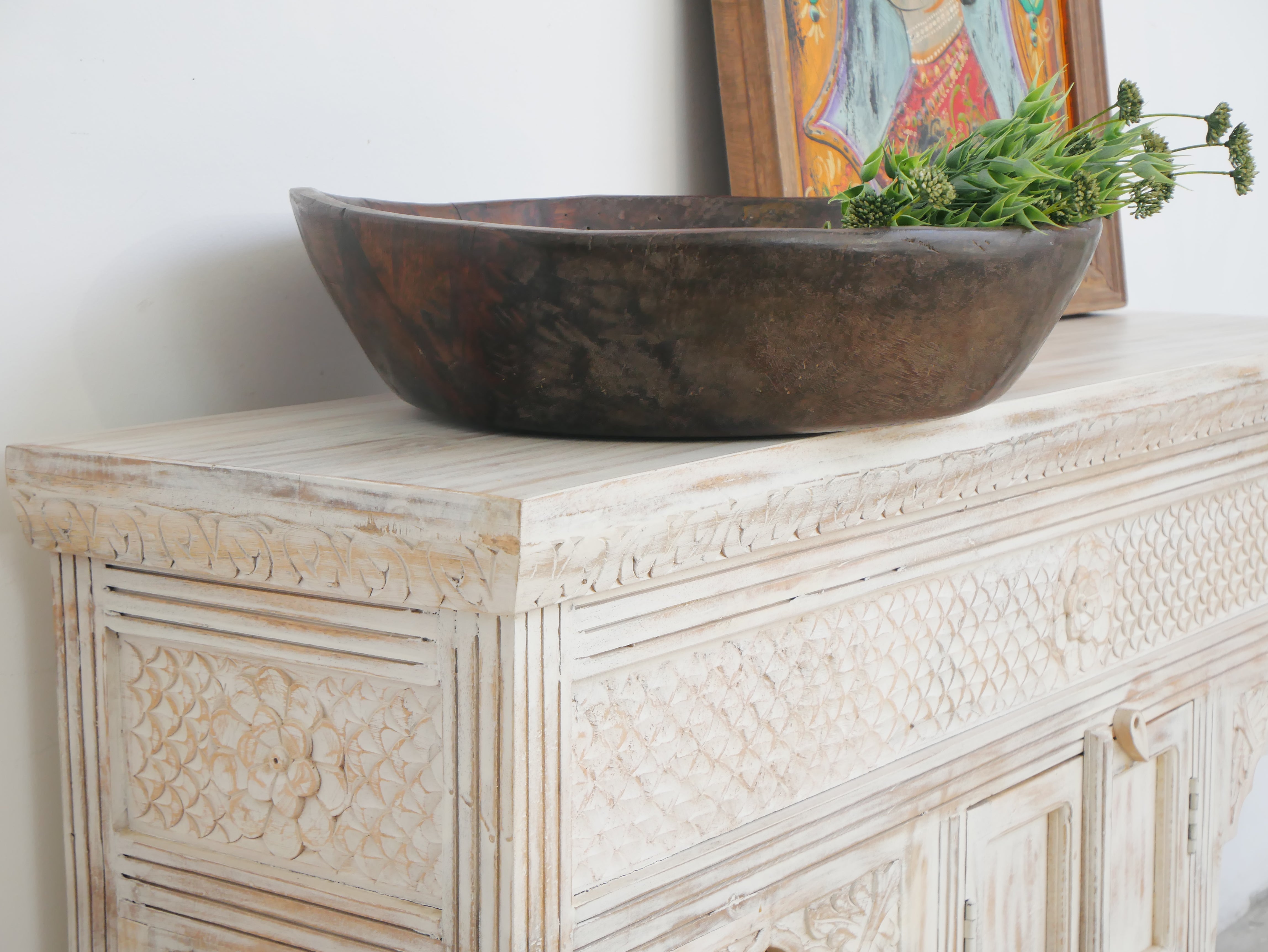 Close up image of a mango wood console table with Oriental hand-carved front; Mediterranean style carved console table with two storage compartments, 150 × 90 × 40 cm.
