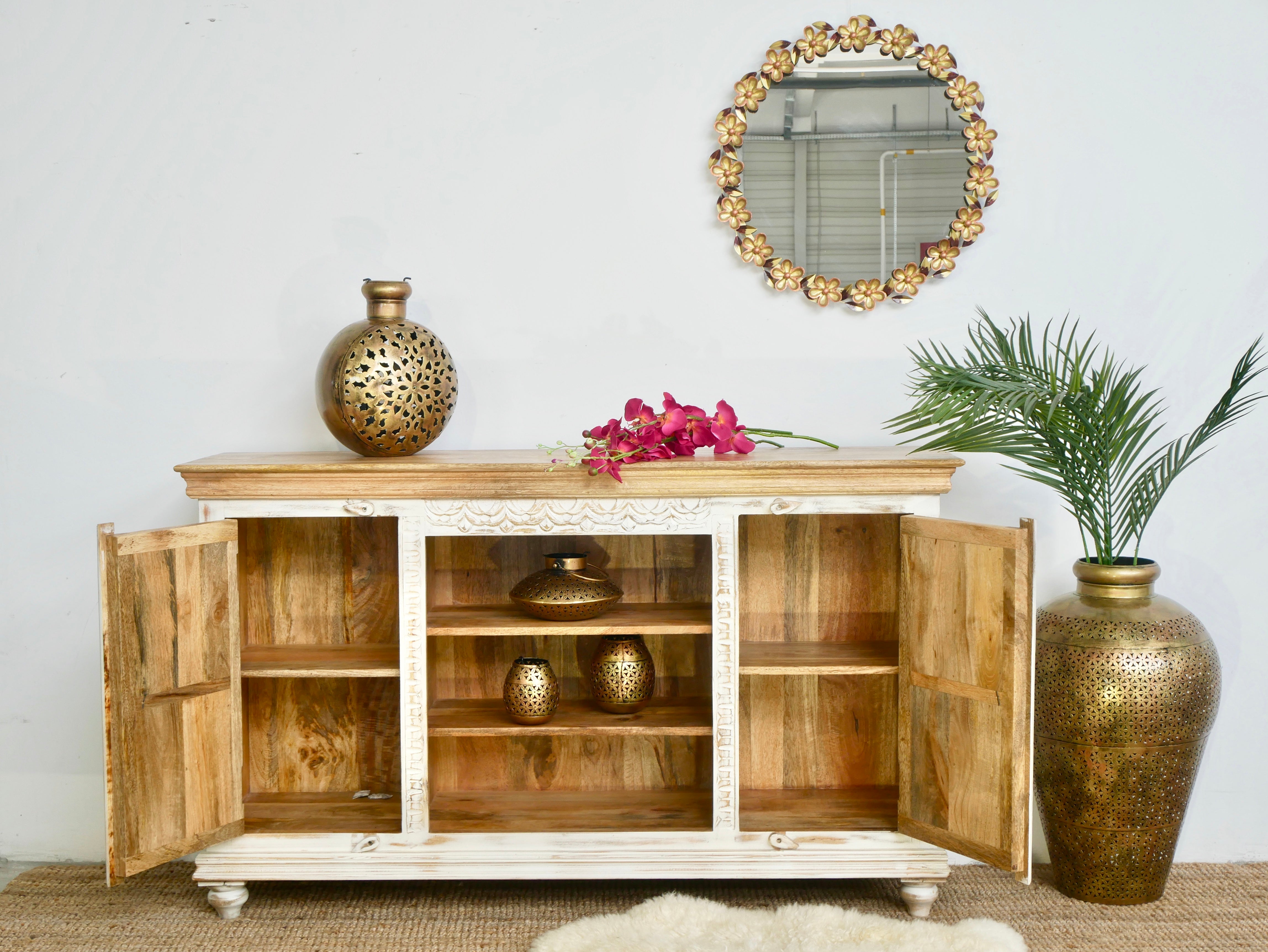 Open door image of a carved mango wood console table with Indian motifs and natural finish; vintage furniture with 3 compartments and 2 drawers, 150 × 75 × 40 cm.