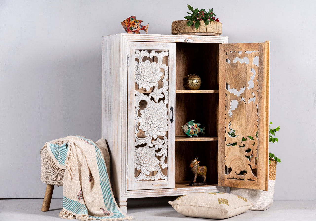 Side angle image with open doors of a white washed mango wood cabinet with three compartments and hand‑carved floral doors, vintage style, 75 × 40 × 120 cm.