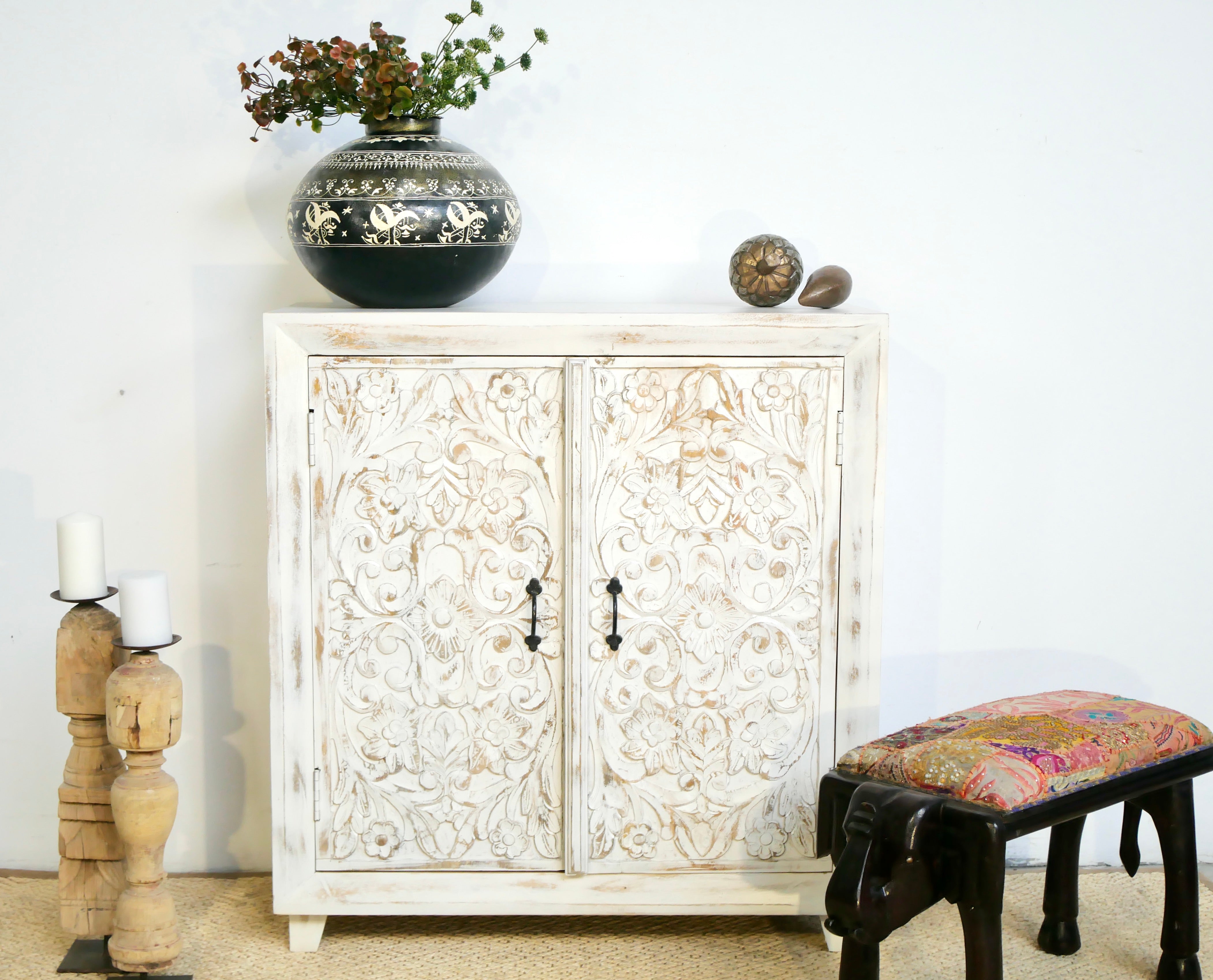 White washed wooden cabinet made from mango wood with hand-carved Indian floral patterns, rustic Mediterranean-style furniture, 90 × 97 × 40 cm.