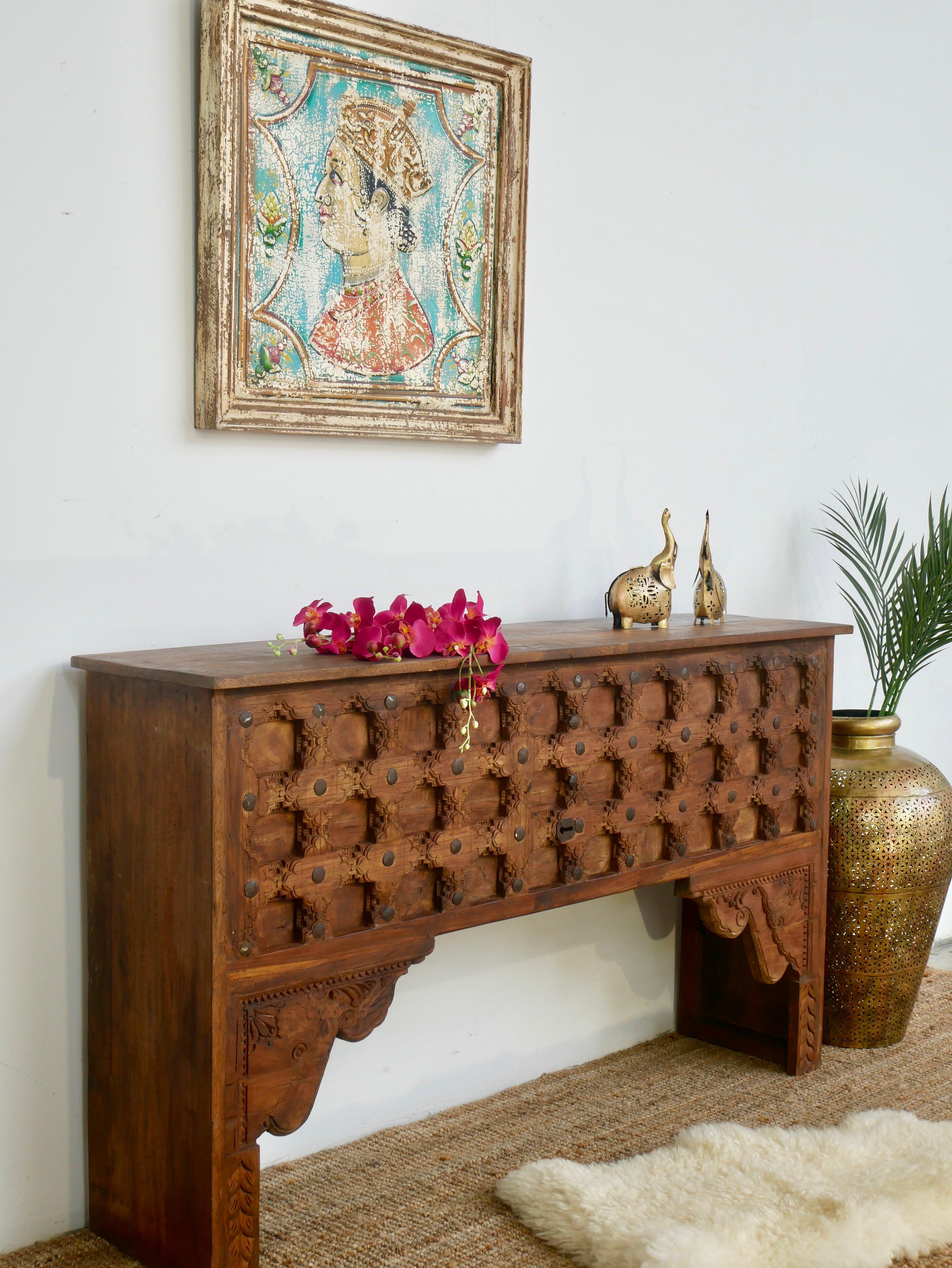 Side angle image of a teak wood console table made from antique Indian door parts; sustainable old door furniture, 183 × 95 × 45 cm.