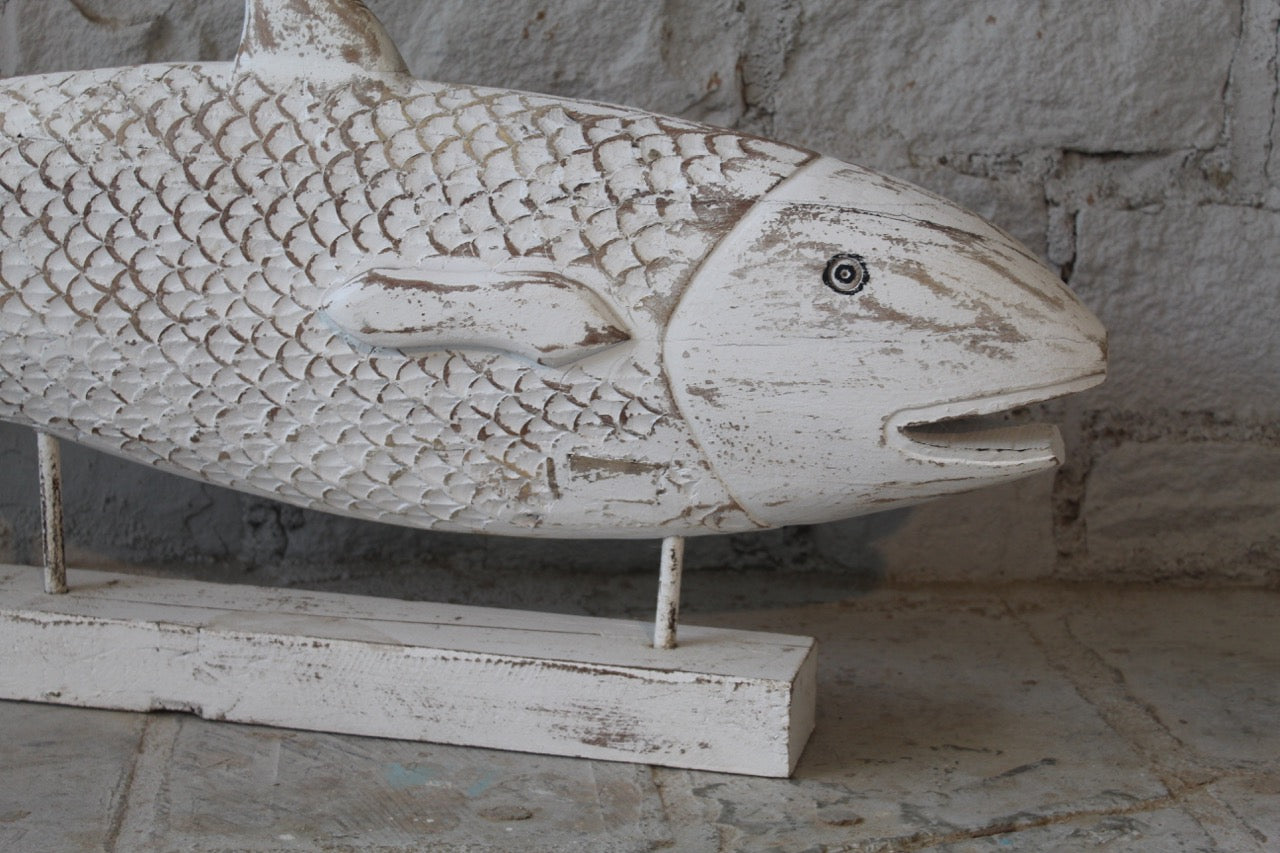 Close up image of a hand-carved fish sculpture made from reclaimed teak wood – a vintage home decor piece ideal for coastal and living room decoration.