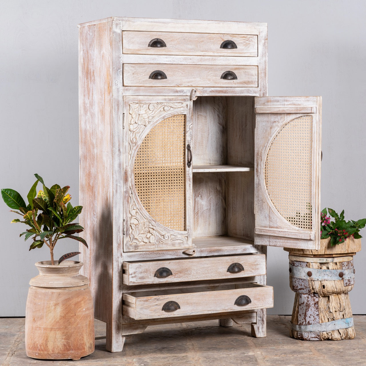 Open door image of a handcrafted mango wood cabinet with rattan doors and carvings, living room furniture in whitewashed finish, 80 × 148 × 40 cm.