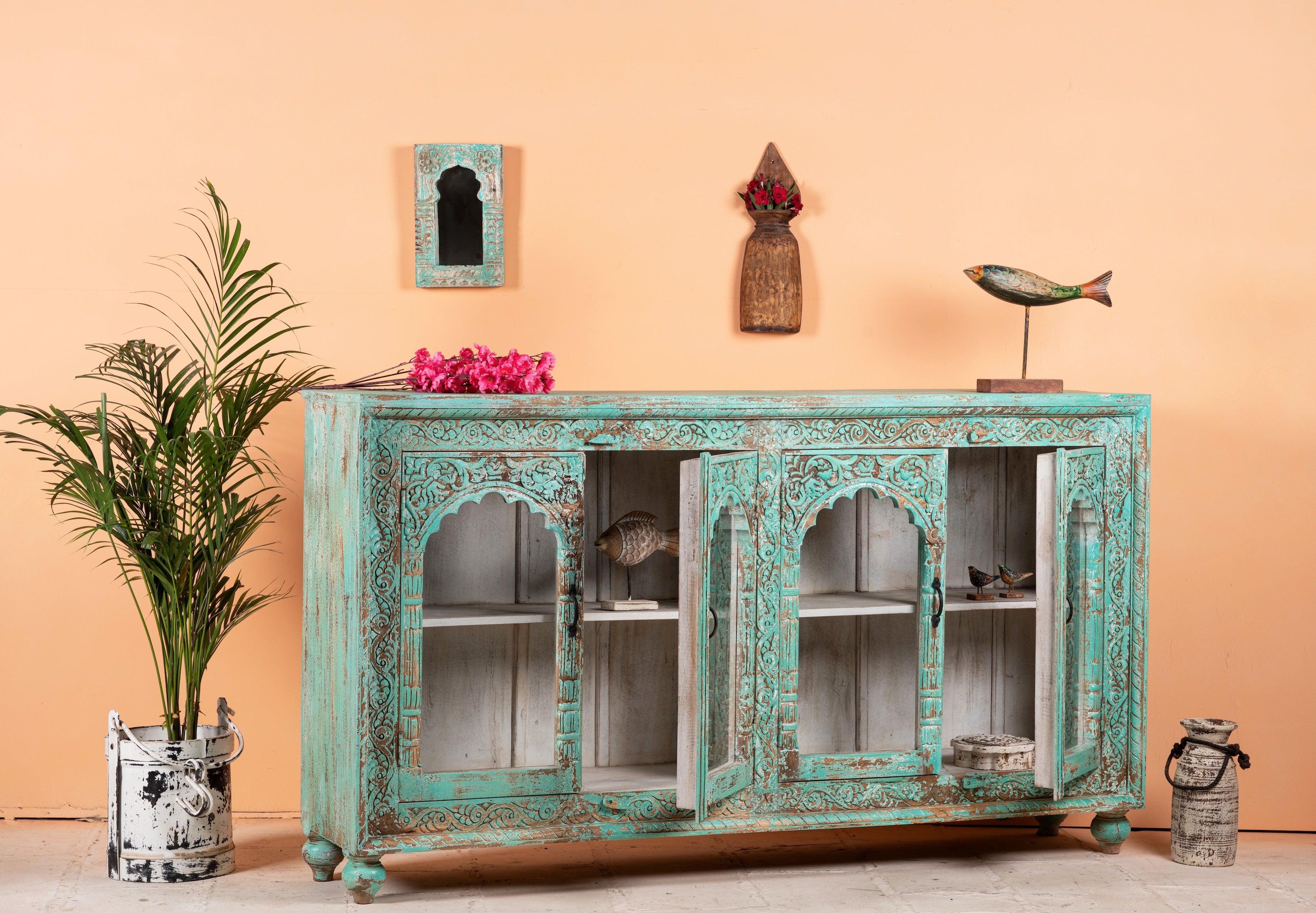 Open door image of Jesar handcrafted turquoise-washed carved wooden sideboard with Indian motifs and open compartments; ideal as living room furniture or carved showcase, 180 × 100 × 40 cm.