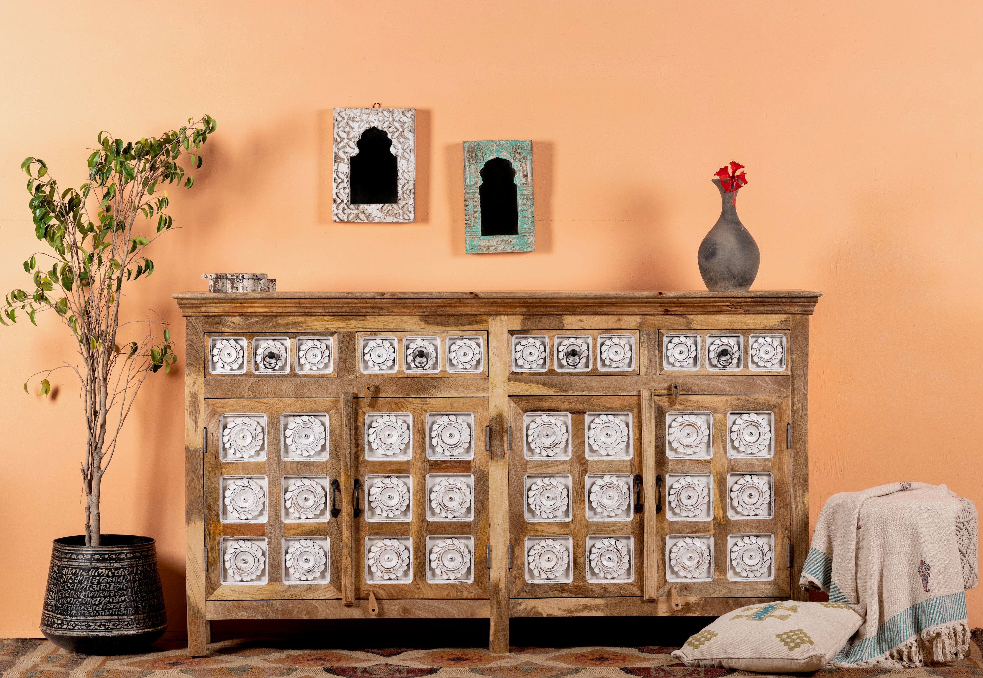 Life style image of a hand-carved mango wood sideboard with whitewashed floral details; perfect as living room furniture or mango wood furniture for vintage interiors, 180 × 100 × 40 cm.