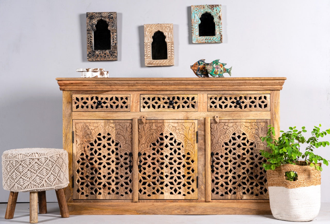 Lifestyle image of a hand-carved mango wood sideboard Kaveri with 6 compartments and 3 drawers, oriental-inspired mango wood furniture, 150 × 90 × 40 cm.