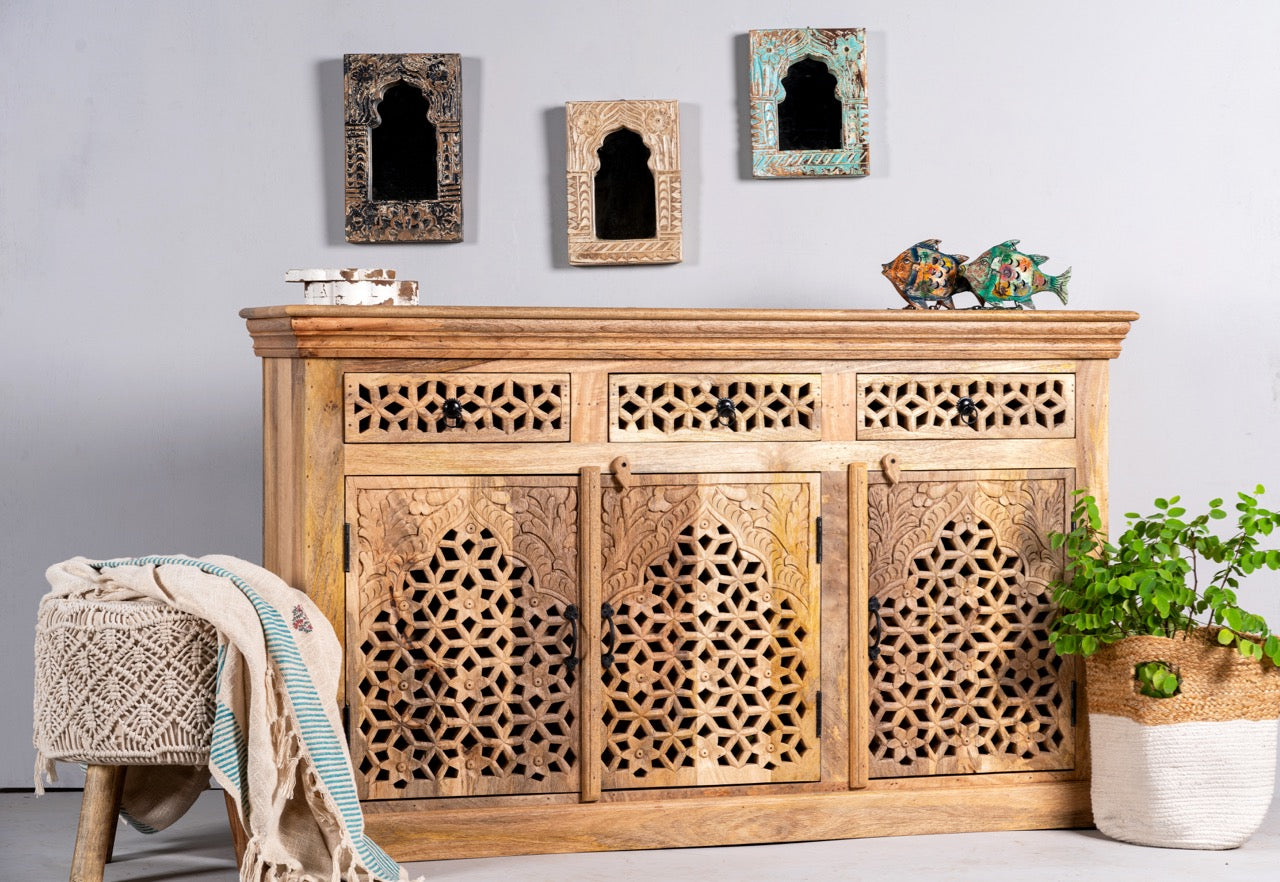 Side angle image of a hand-carved mango wood sideboard Kaveri with 6 compartments and 3 drawers, oriental-inspired mango wood furniture, 150 × 90 × 40 cm.