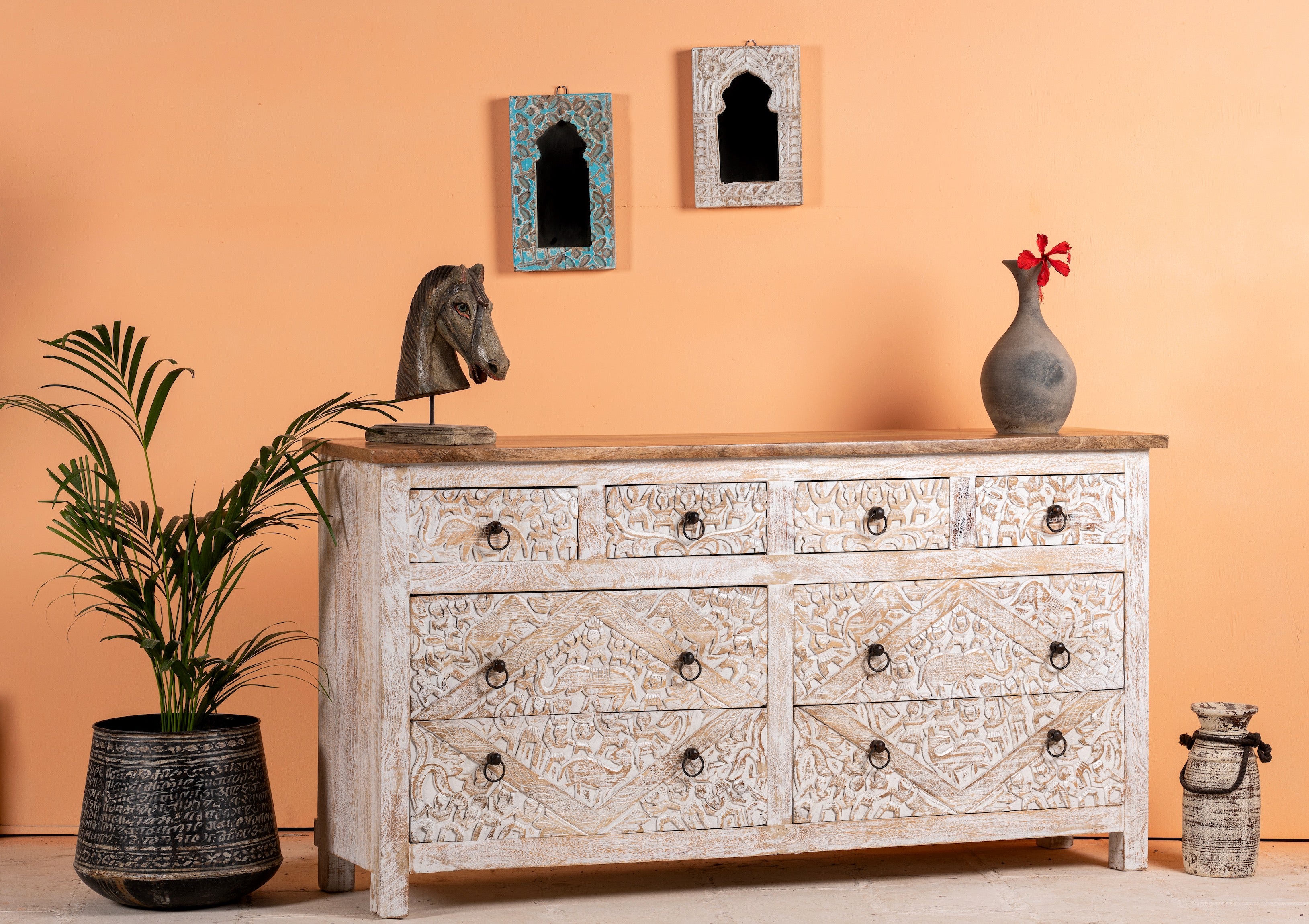 Side angle image of a hand-carved mango wood sideboard with elephant motifs and whitewashed finish; ideal for vintage home decor, 153 × 80 × 40 cm.