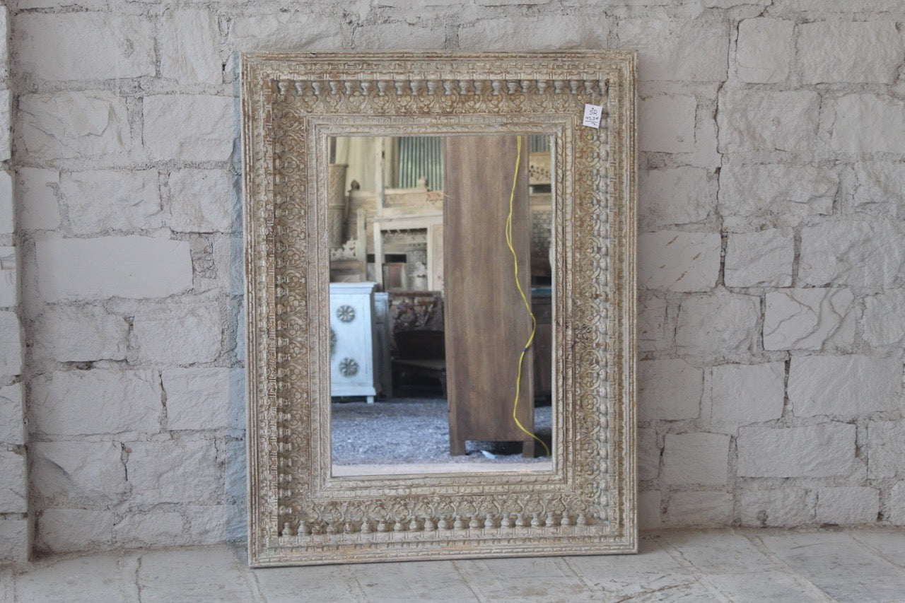 Warehouse image of a vintage wall mirror with hand carved wooden mango wood frame; large rectangular mirror, 100 × 130 cm.