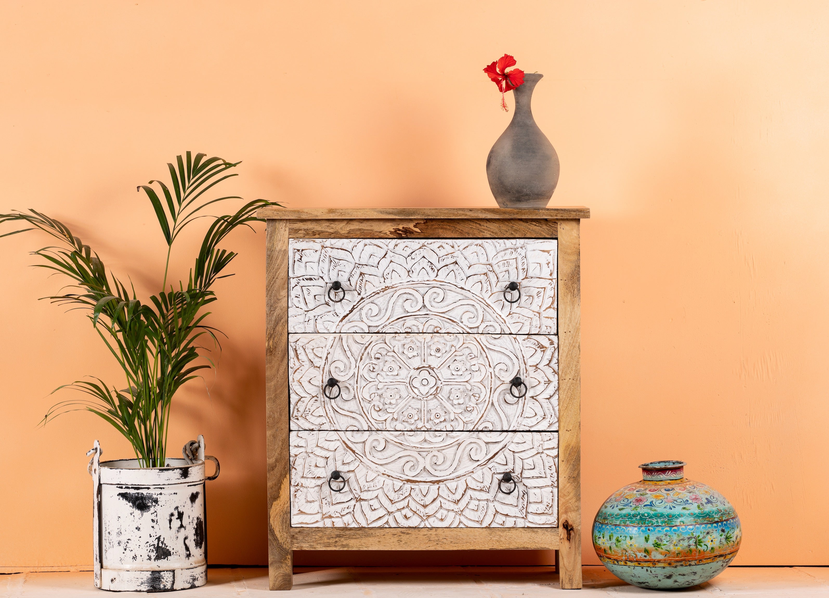 Mango wood carved chest of drawers with whitewashed floral engraved fronts, 80 × 40 × 90 cm.