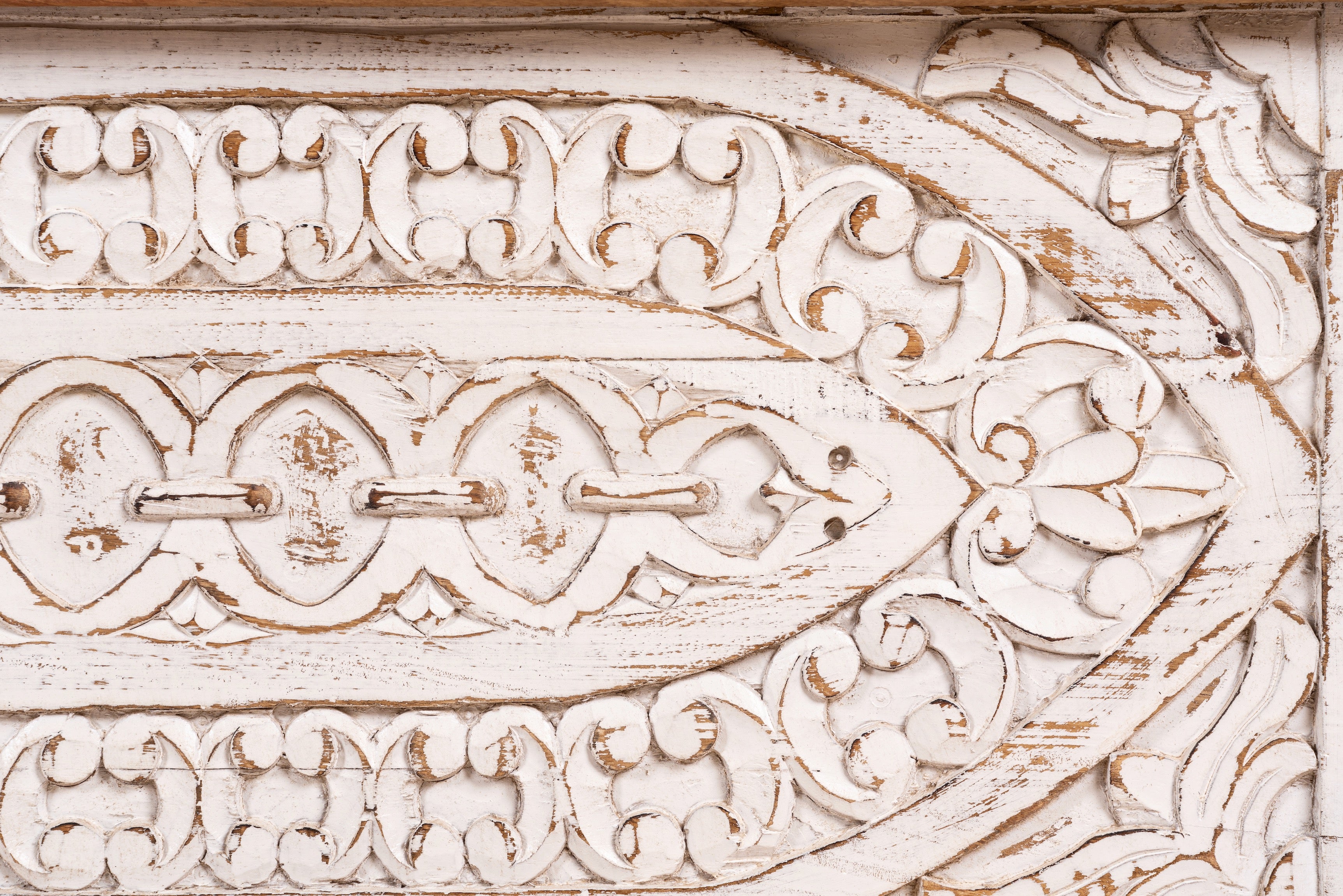 Close up image of a hand-carved mango wood vintage chest with whitewashed finish and iron fittings – elegant storage for bohemian or rustic interiors.