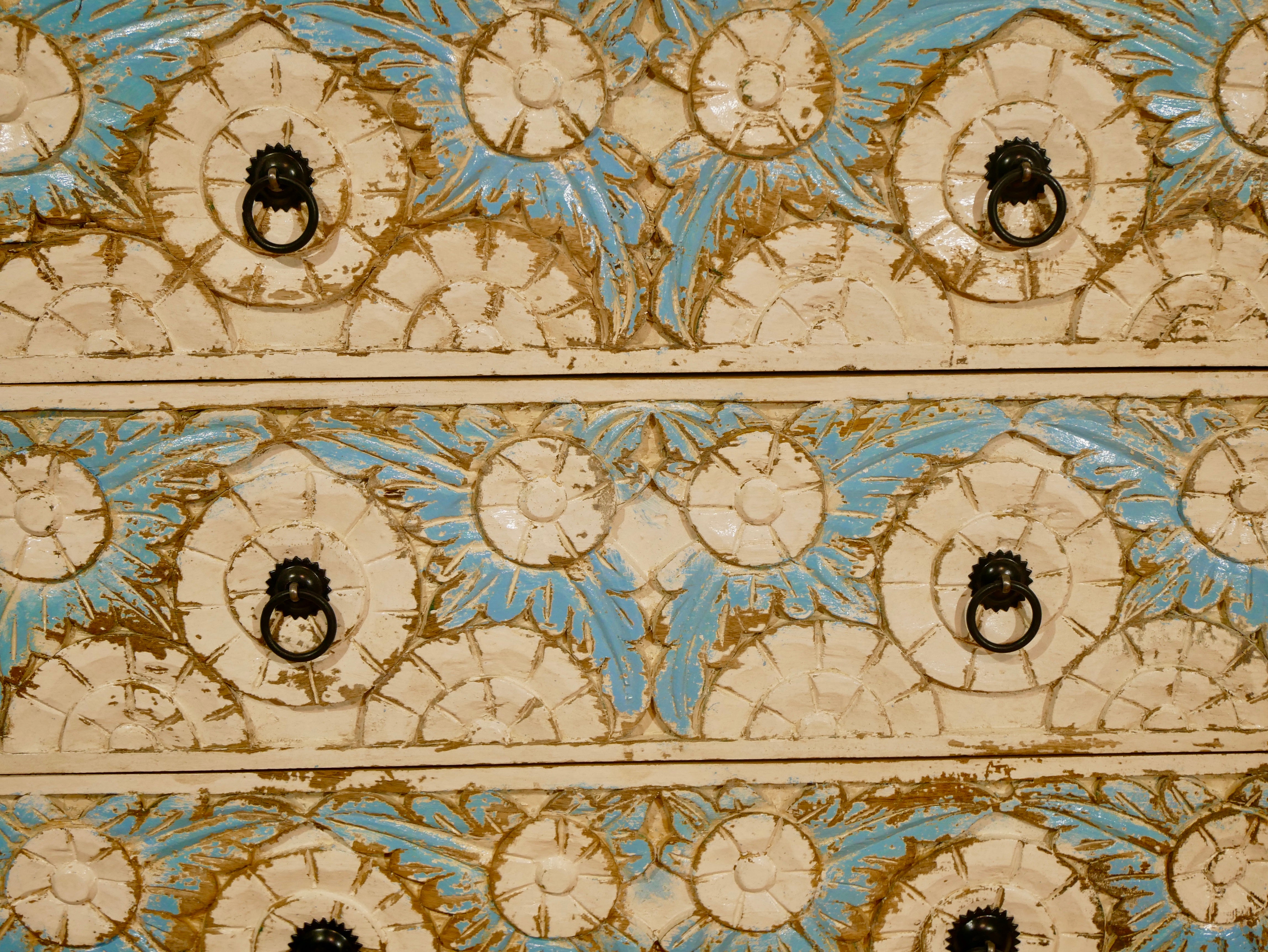 Close up image of a Boho style carved drawer chest made from solid mango wood with floral hand-carved details, Mediterranean design, 80 × 75 × 35 cm.