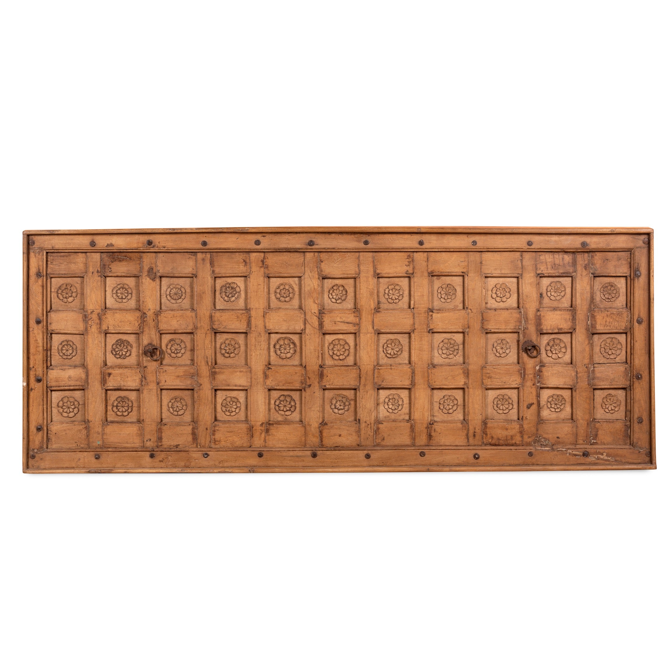 White background image of a Okha antique Indian teak door repurposed as a decorative wall panel or old door headboard, featuring original hand-carved detailing and a naturally aged finish—an authentic piece of old Indian door furniture.