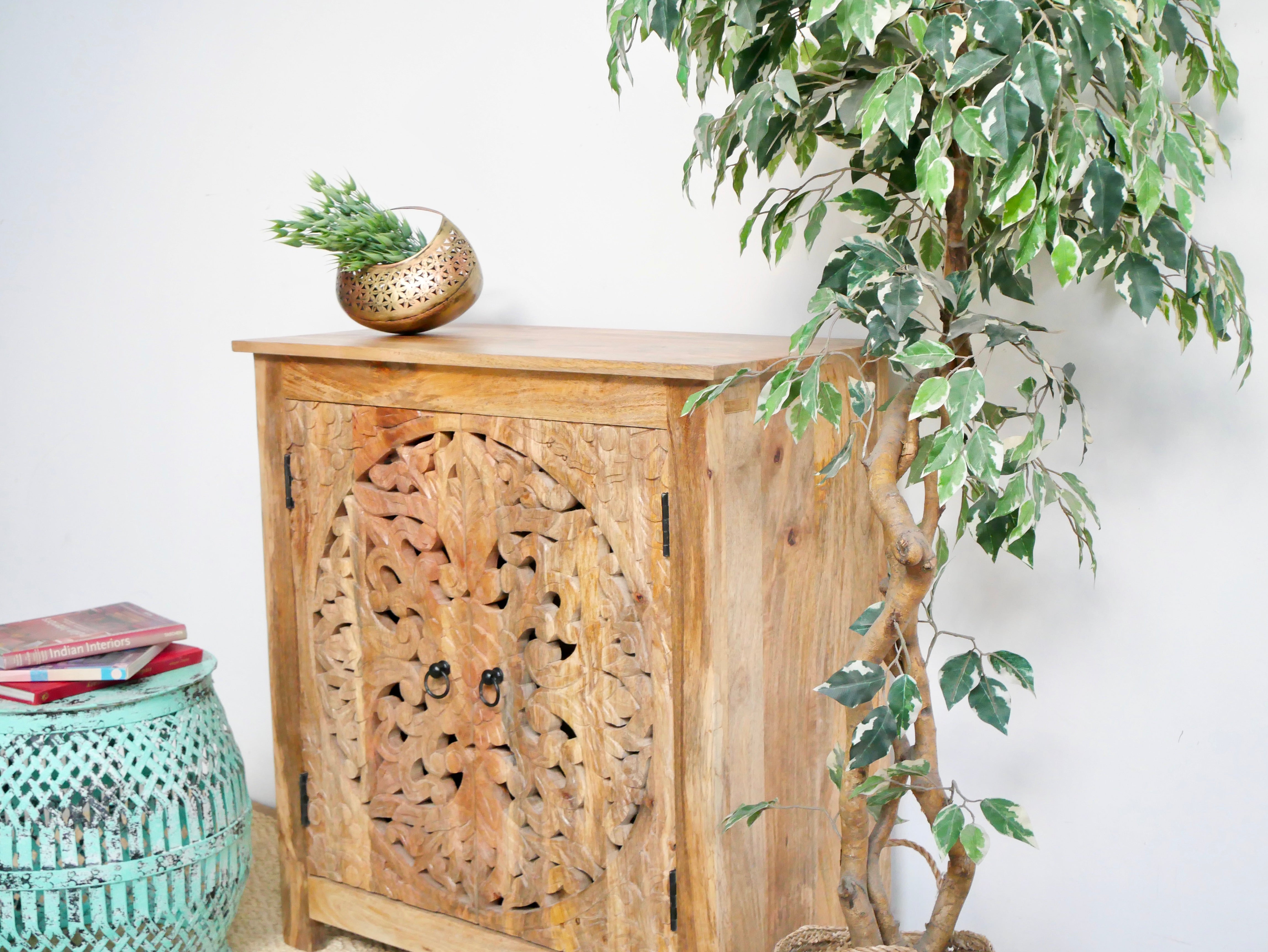 Side angle image of a carved wood furniture cabinet made from solid mango wood, Mediterranean-style with Indian floral carvings, 90 × 90 × 40 cm.