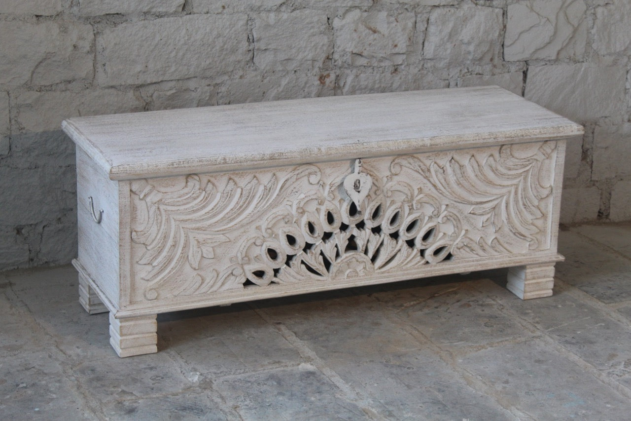 Side angle image of a hand-carved mango wood vintage chest with floral detailing – a one-of-a-kind mango wood chest ideal for Mediterranean-inspired interiors.