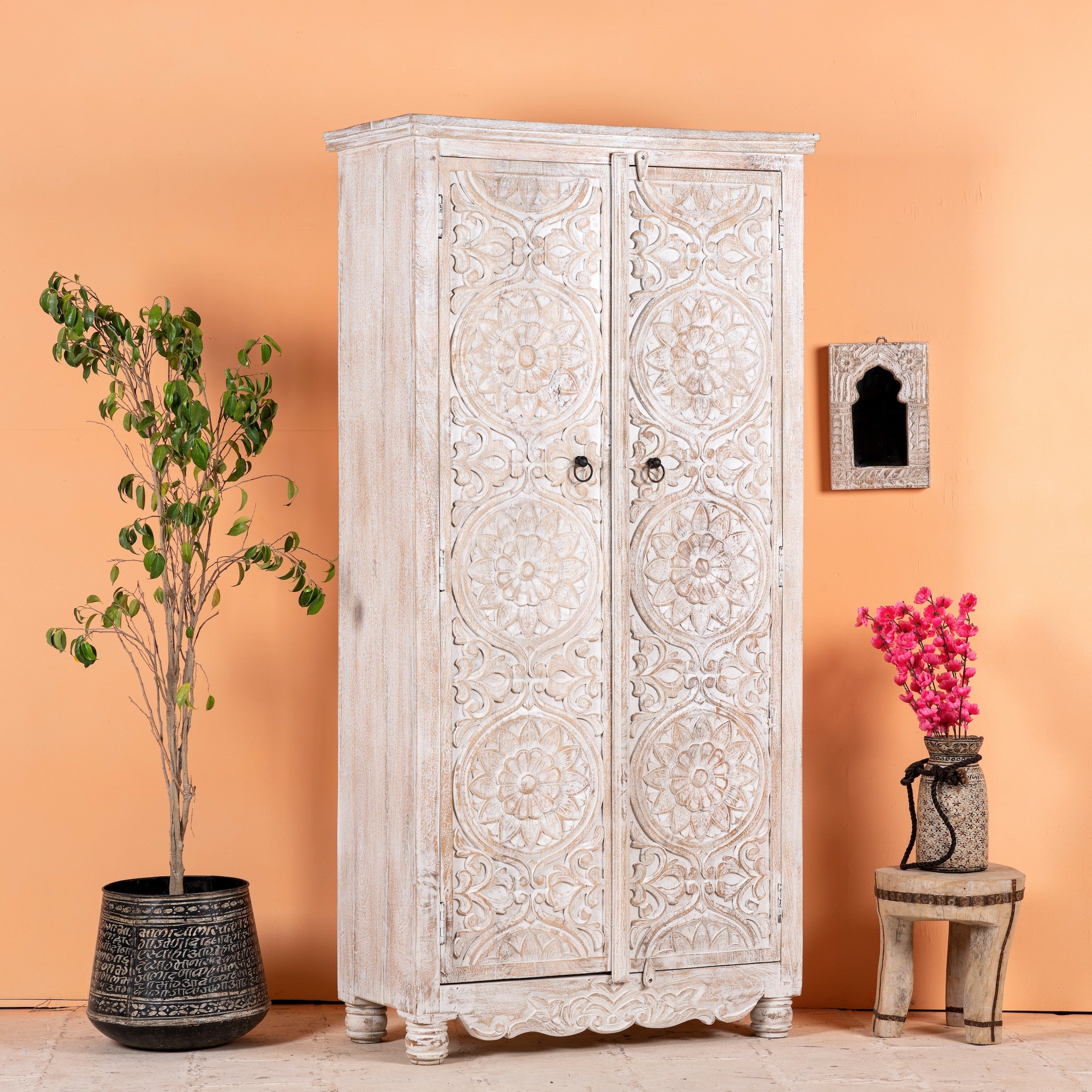 Side angle image of a hand-carved mango wood wardrobe with whitewashed finish; wooden wardrobe perfect for living room furniture or bedroom storage, 180 × 90 × 40 cm.