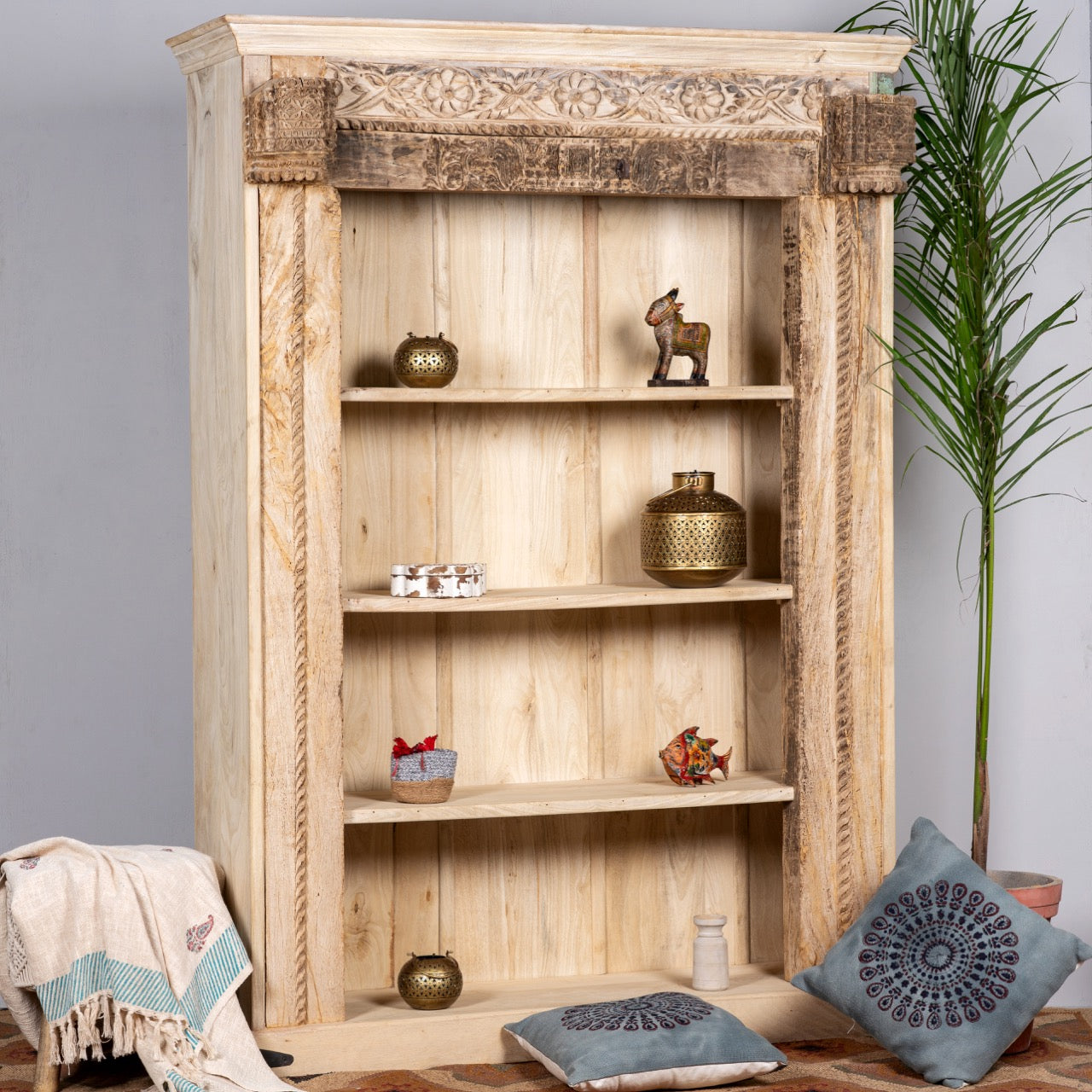 Side angle image of a hand-carved shelf made from reclaimed teak wood and mango wood, unique furniture with Ibiza-inspired finish, 150 × 208 × 52 cm.