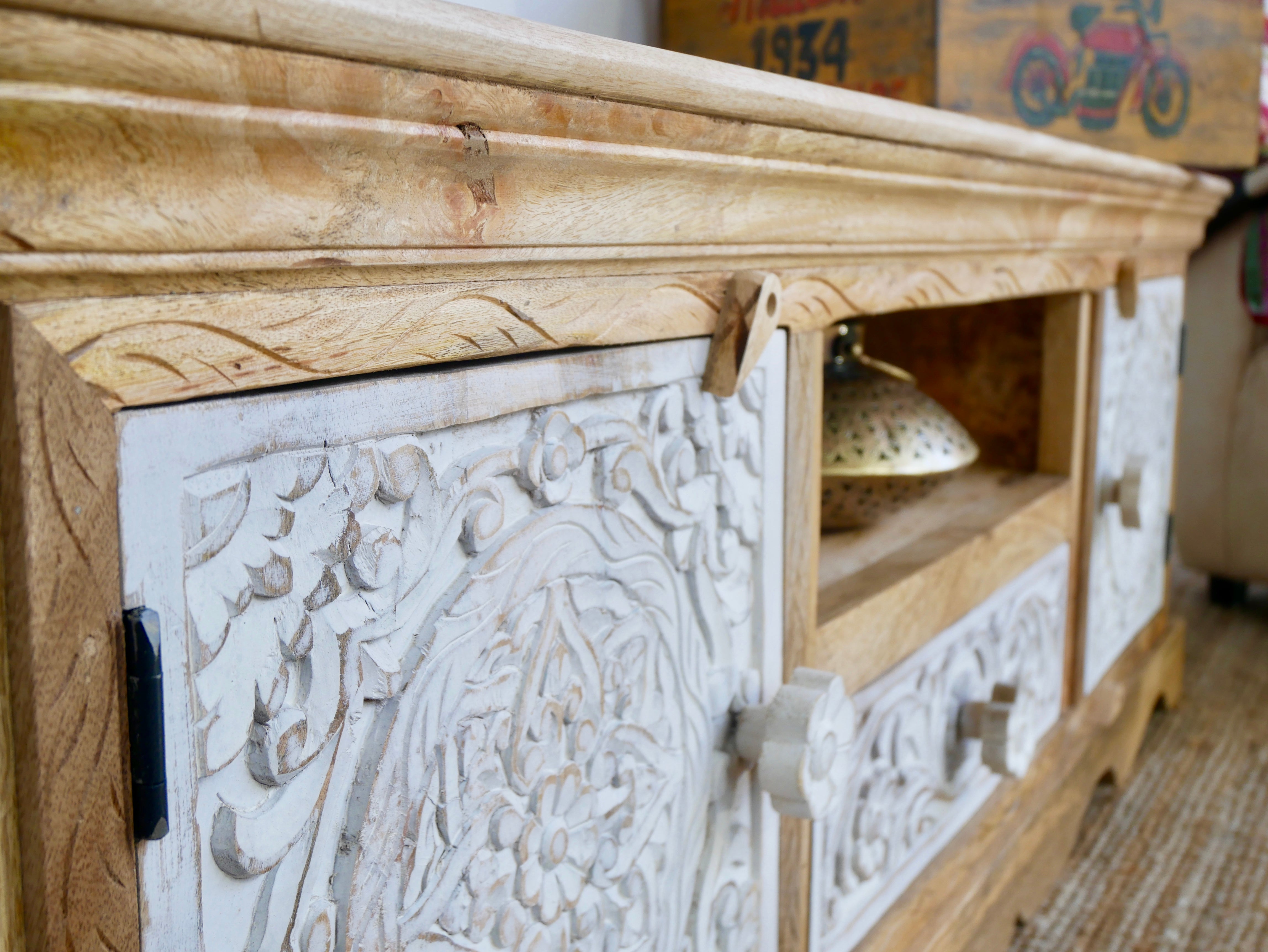 Close up image of a handcrafted wooden carved sideboard made from mango wood with Indian carvings and drawers; ideal living room furniture, 150 × 60 × 40 cm.