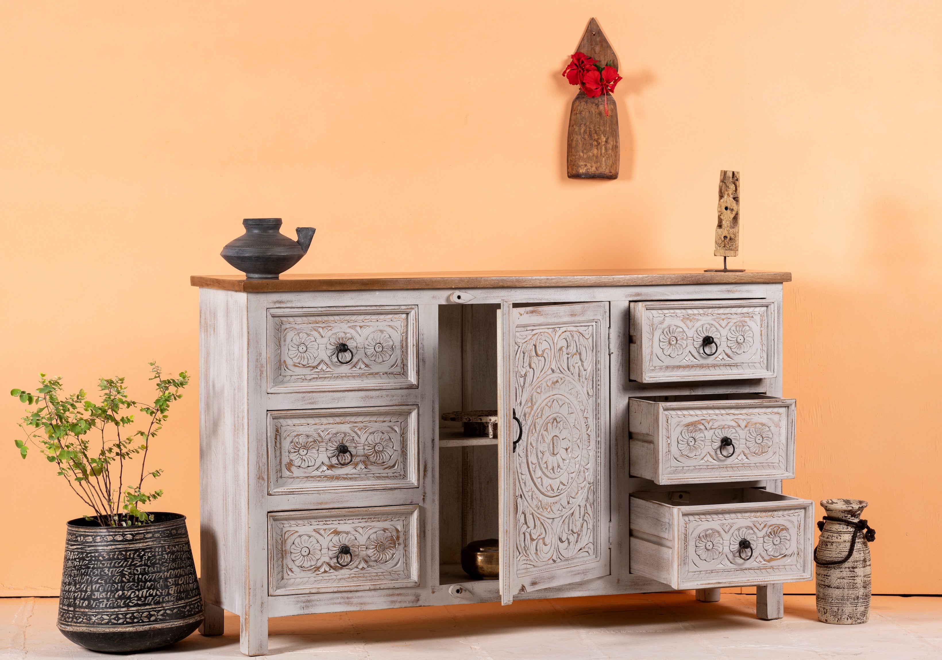image of a andcrafted mango wood sideboard with carved floral motifs, whitewashed base and natural top; perfect for vintage home decor and living room furniture, 150 × 40 × 90 cm.Open drawer