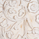Close up image of a white-washed hand-carved mango wood cabinet in Ibiza style, a statement piece for vintage home decor.
