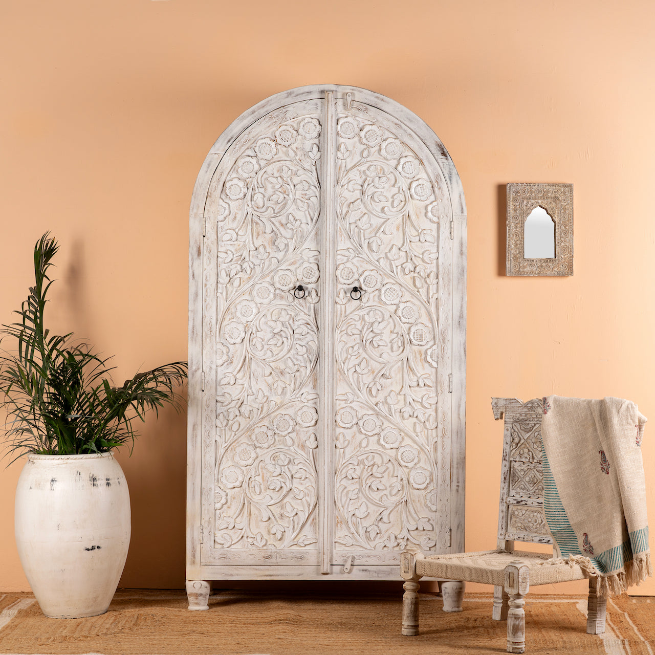 White-washed hand-carved mango wood cabinet in Ibiza style, a statement piece for vintage home decor.