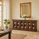 Lifestyle imagination of a reclaimed teak furniture sideboard with glass doors, rustic living room furniture with boho style, 257 × 46 × 100 cm.