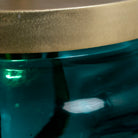 Close up image of a retro pendant lamp with large green glass shade and brass-plated iron frame – vibrant glass lamp ideal for dining rooms, living spaces, or bedrooms.