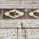 Close up image of a reclaimed teak wood cabinet in shabby chic white with glass doors and ceramic inlays – dining room furniture with vintage elegance.