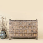 Front view of an antique console table wood counter with open shelves, a one-of-a-kind teak piece of unique furniture.