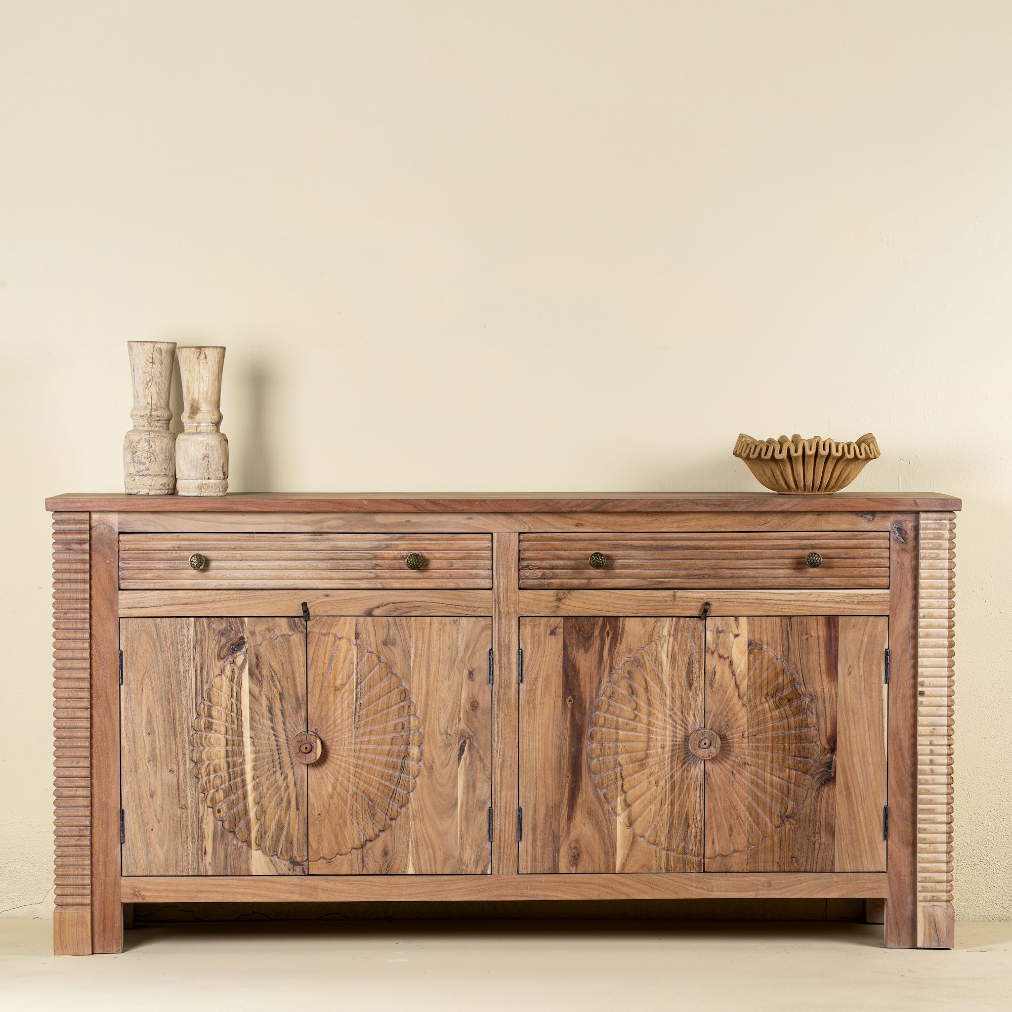 Front view of a modern style handcrafted acacia wood sideboard with 4 doors and 2 drawers with sunburst carvings.