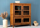 Side angle image with open doors of a reclaimed teak wood display cabinet with four glass-panelled doors – wooden showcase cabinet crafted as sustainable furniture with timeless appeal.
