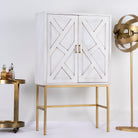 Side angle image of a tall whitewashed mango wood cabinet with carved lines and antique brass iron base, 91 × 154 × 43 cm.