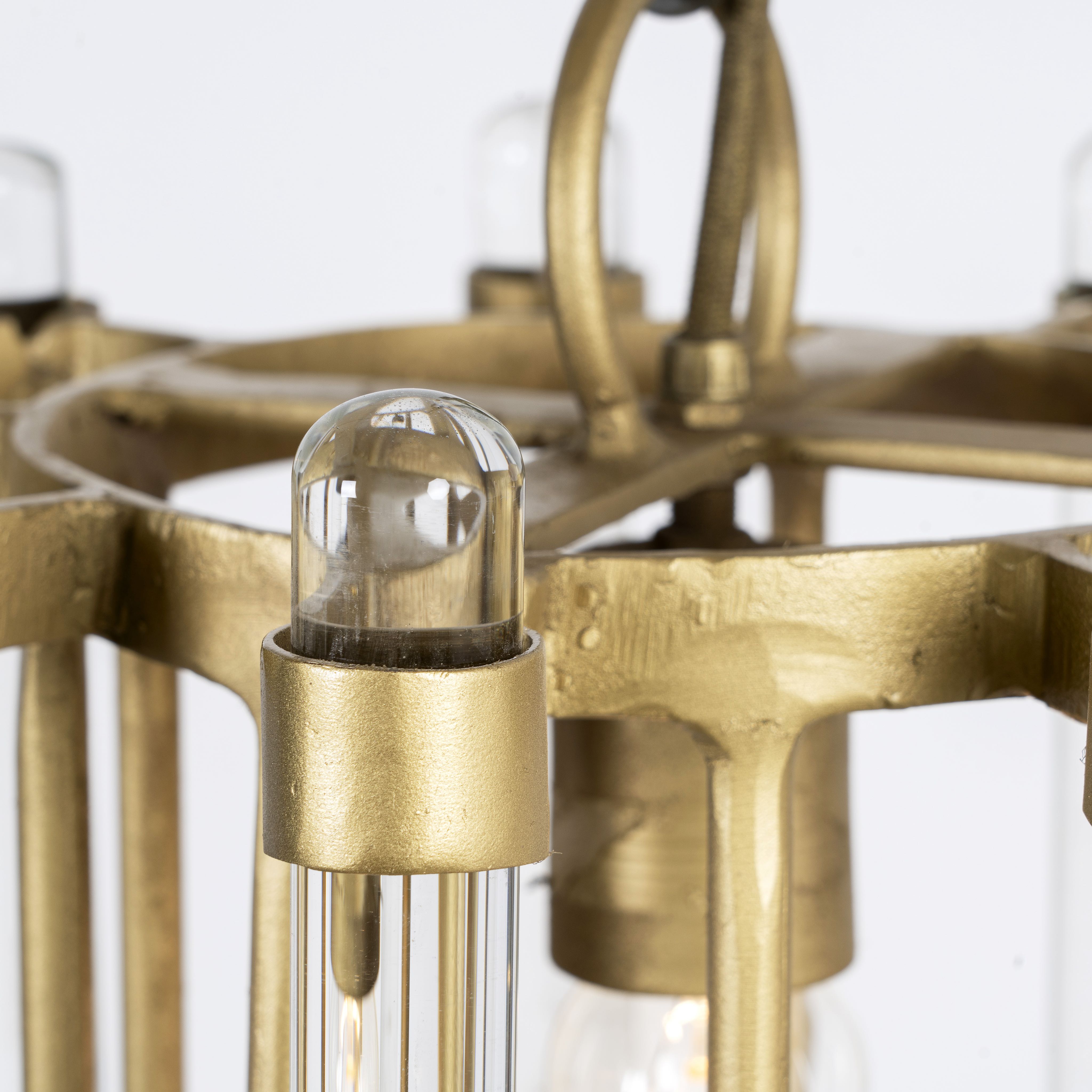 Close up image of a round antique brass iron and glass pendant light with test tube shade – minimalistic pendant light ideal for soft glass lighting in bedrooms, kitchens, or entryways.