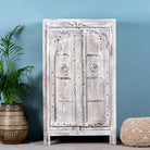 Handcrafted cabinet with reclaimed Indian window frame doors, white-washed finish, and iron accents – vintage home decor with teak furniture appeal.