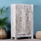 Side angle image of a handcrafted cabinet with reclaimed Indian window frame doors, white-washed finish, and iron accents – vintage home decor with teak furniture appeal.