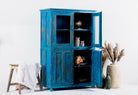 Side angle image of a refurbished blue teak wood showcase with glass and wooden doors – sustainable dining room furniture crafted from reclaimed teak with vintage flair.