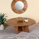 Side angle image of a round mango wood coffee table with rustic finish and cross-base design, Dia 120 × H 45 cm, living room furniture.