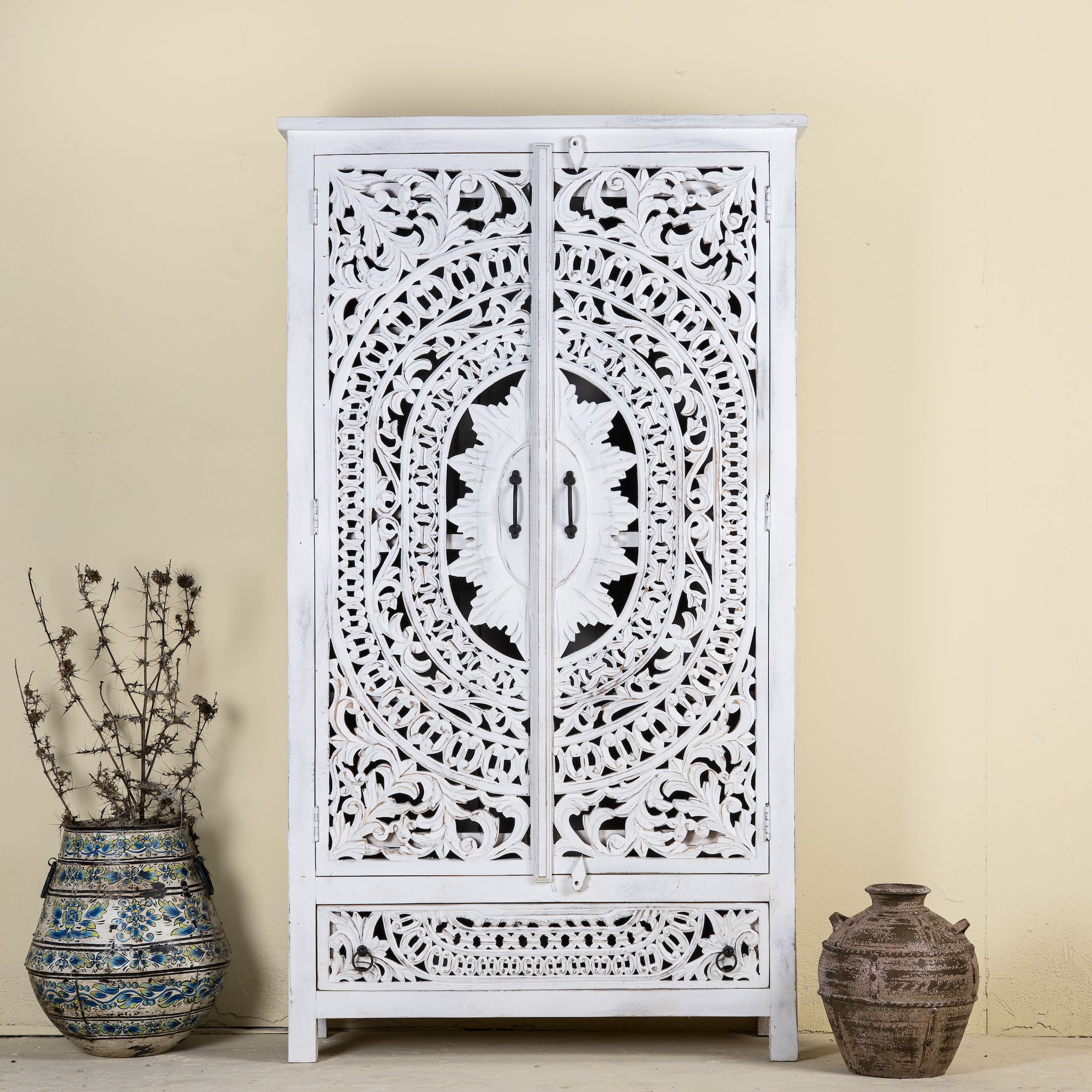 Hand-carved wooden wardrobe in white-wash finish, perfect for a boho chic living room or bedroom storage.