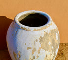 Close up image of a antique-style Indian clay vase with wide shape – a handcrafted Bali style clay vase ideal for Indian home decoration and bohemian interiors.