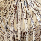 Close up image of a Daiwik whitewashed metal pendant light with sculptural openwork lantern design and iron chain—an eye-catching example of hand crafted metal lamps and artisan metal pendant lights.