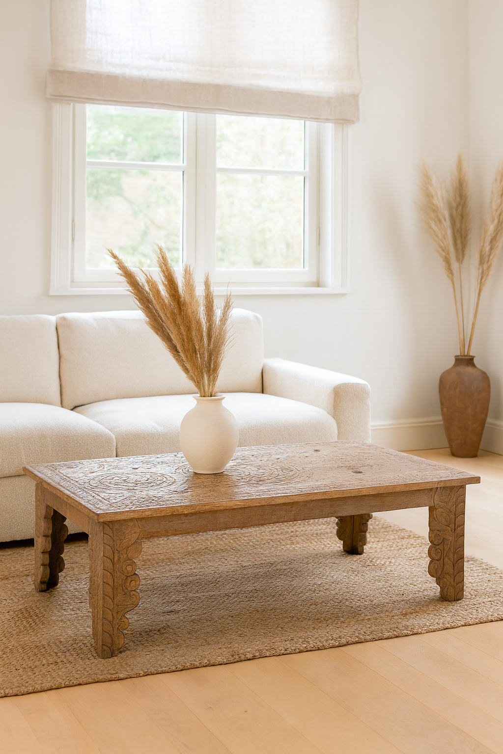 Lifestyle imagination of a sandblasted reclaimed teak wood coffee table with carved antique Indian door top; unique teak wood furniture and living room furniture, 140 × 40 × 48 cm.