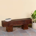 Side angle image of a rustic wood bench made of reclaimed wood, full block design, sustainable furniture for hallways, living rooms, or terraces, 200 × 30 × 40 cm.