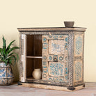 Side angle image with open door of a hand-painted cupboard made from reclaimed wood and old Indian doors – a sustainable furniture piece perfect for Indian home decor and rustic interiors.