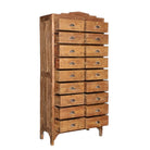 Side angle image with open drawers of a tall teak wood furniture chest of drawers with 18 drawers and iron handles, in natural teak finish, 88 × 190 × 40 cm